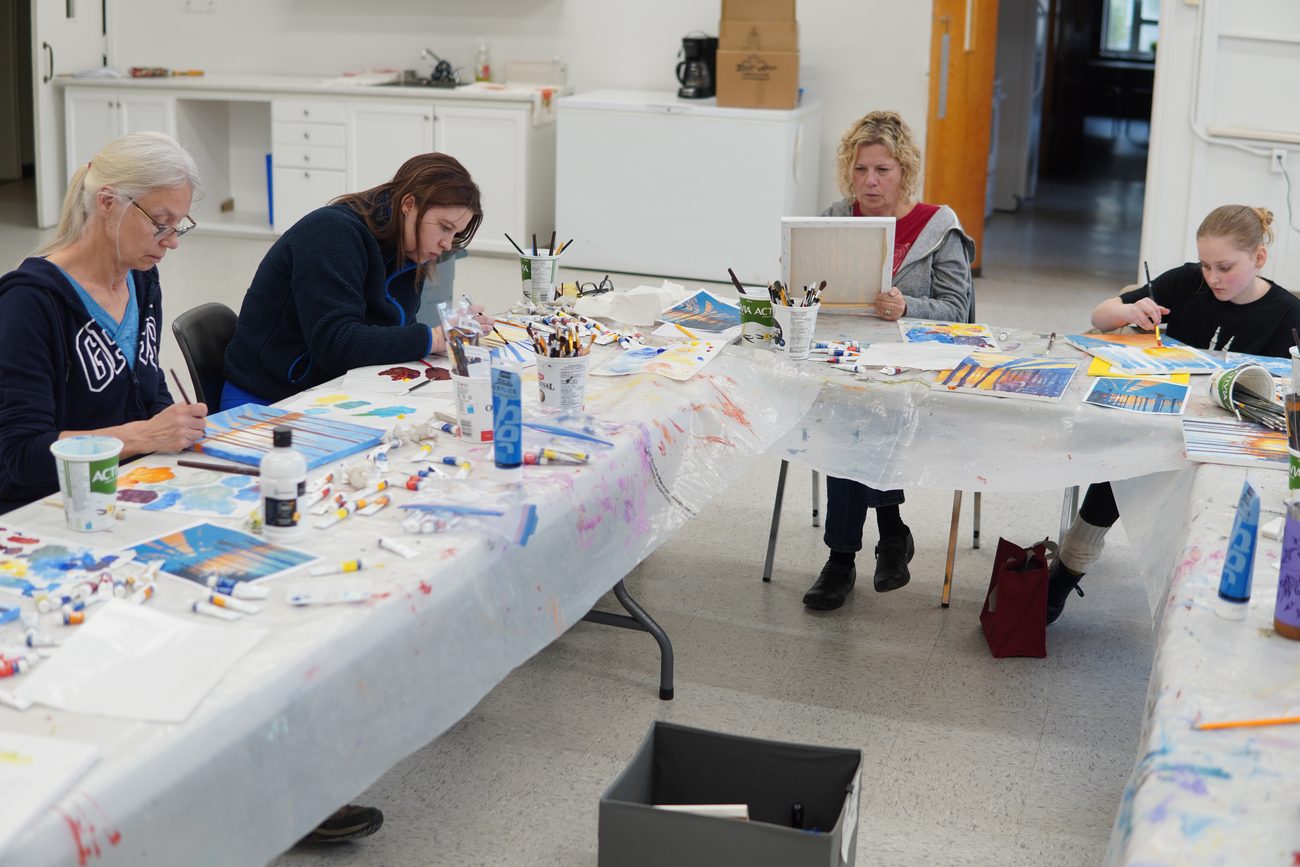 Adult students painting Lake Huron sunsets at a South Huron Arts Centre workshop